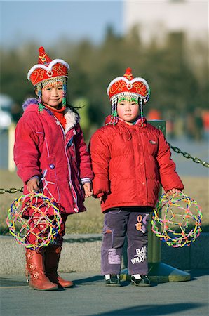 China,Beijing. Chinese New Year Spring Festival Two cute girls dressed up in minority costume clothing. Stock Photo - Rights-Managed, Code: 862-03351553