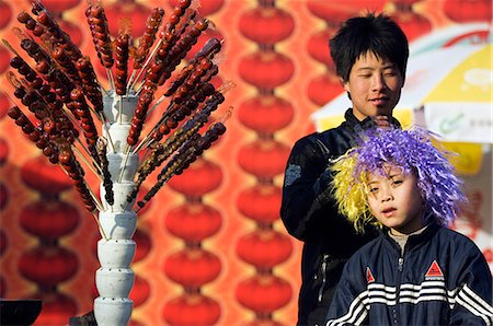 China, Peking. Chinese New Year Spring Festival - zwei Jungs in einen süßen Hawthorne-Stand im Longtanhu Park Fair. Stockbilder - Lizenzpflichtiges, Bildnummer: 862-03351581