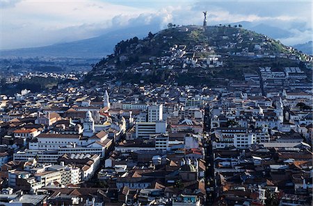 ecuador capital city pictures - View over downtown Quito,capital city of Ecuador. The city centre contains many fine examples of Spanish colonial architecture and is a UNESCO World Heritage site. A 41m statue of the Virgin of Quito,completed in 1976,stands atop the hill known as El Panacillo (the little bread roll). Stock Photo - Rights-Managed, Code: 862-03352669