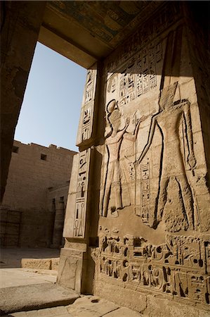 simsearch:862-03352903,k - Beautiful carvings and heiroglyphs cover the walls of the mortuary temple of Ramses III at Medinet Habu on the West Bank,Luxor,Egypt Stock Photo - Rights-Managed, Code: 862-03352905