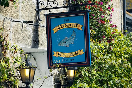 The sign outside the Grey Mullet Guest House in the Fifherman's Quater of St Ives,Cornwall. Once the home of one of the largest fishing fleets in Britain,the industry has since gone into decline. Tourism is now the primary industry of this popular seaside resort town. Stock Photo - Rights-Managed, Code: 862-03353052
