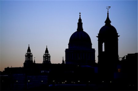 simsearch:862-03353145,k - Silhouette of St Pauls Cathedral and one of the towers of Canon Street station against the evening sky. Stock Photo - Rights-Managed, Code: 862-03353143