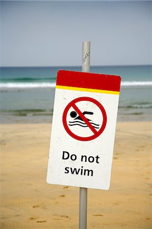 simsearch:851-02963719,k - Do Not Swim sign warns holiday makers not to swim among the surfers on Fistral Beach,Newquay Stock Photo - Rights-Managed, Code: 862-03353233