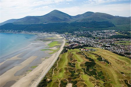 The Royal County Down golf course with the Slieve Donard Hotel,the small coastal town of Newcastle and the Mountains of Mourne behind Stock Photo - Rights-Managed, Code: 862-03353267