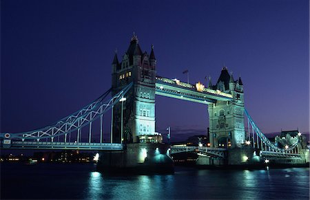 The Tower Bridge crossing the River Thames in central London. The bridge designed by Sir Horace Jones and built in 1894,was designed as a drawbridge to allow ships to pass through. Stock Photo - Rights-Managed, Code: 862-03353308
