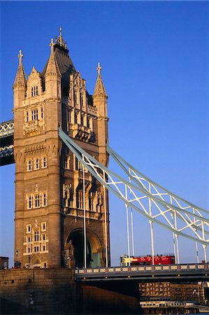 The Tower Bridge crossing the River Thames in central London. The bridge designed by Sir Horace Jones and built in 1894,was designed as a drawbridge to allow ships to pass through. Stock Photo - Rights-Managed, Code: 862-03353316