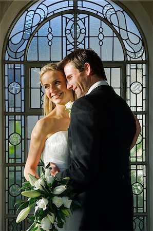 enniskillen - United Kingdom,Northern Ireland,Fermanagh,Enniskillen. Bride and groom embrace during their wedding at the Lough Erne Golf Resort Hotel . Fotografie stock - Rights-Managed, Codice: 862-03353441