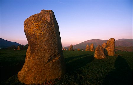 england ancient standing stone - England,Cumbria,Keswick. Castlerigg Stone Circle - there are 38 stones in a circle approximately 30 metres in diameter. Within the ring is a rectangle of a further 10 standing stones. The tallest stone is 2.3 metres high. It was probably built around 3000 BC - the beginning of the later Neolithic Period - and is one of the earliest stone circles in Britain. Stock Photo - Rights-Managed, Code: 862-03353452