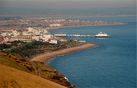 simsearch:862-03353057,k - England,East Sussex,Eastbourne. Eastbourne is situated at the eastern end of the South Downs alongside the famous Beachy Head cliff. The sheltered position of the main town behind the cliff contributes to Eastbournes title of sunniest place in Great Britain. Stock Photo - Rights-Managed, Code: 862-03353585