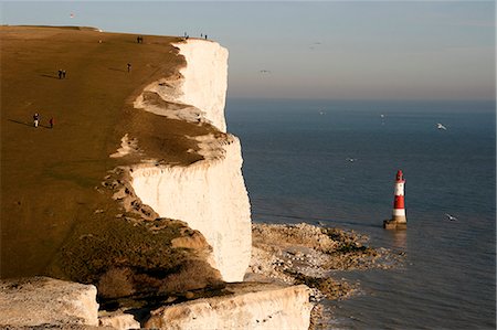 simsearch:400-05025778,k - England,East Sussex,Beachy Head. Beachy Head is a chalk headland on the south coast of England,close to the town of Eastbourne. The cliff there is the highest chalk sea cliff in Britain,rising to 162 m (530 ft) above sea level. The peak allows views of the south east coast from Dungeness to the east,to Selsey Bill in the west. Stock Photo - Rights-Managed, Code: 862-03353589