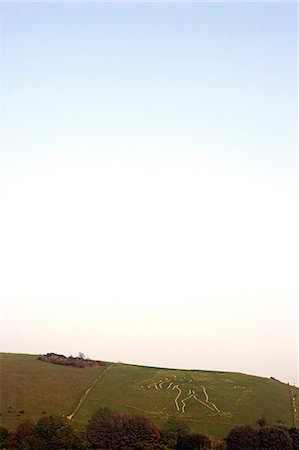 simsearch:862-03353670,k - Angleterre, Dorset, Cerne Abbas. Le géant de Cerne Abbas ou l'homme Rude est le plus grand hillfigure en Grande-Bretagne, il est l'un des deux représentations du corps humain, l'autre étant le Long Man of Wilmington dans l'East Sussex. Le géant, sculpté en traits pleins de la roche de la craie, mesures à 180 mètres de haut et porte un club énorme noueuse, qui mesure 40 mètres de long. Photographie de stock - Rights-Managed, Code: 862-03353678