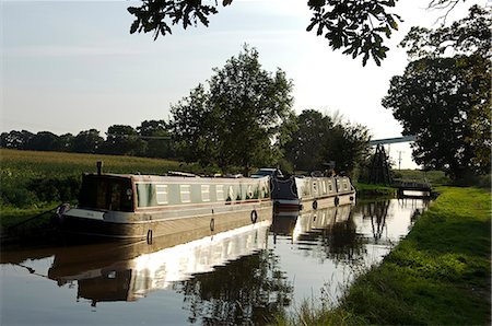 England,Shropshire,Whitchurch. Barges on a tranquil section of the Shropshire Union Canal. Stock Photo - Rights-Managed, Code: 862-03353790