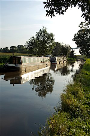 England,Shropshire,Whitchurch. Barges on a tranquil section of the Shropshire Union Canal. Stock Photo - Rights-Managed, Code: 862-03353791