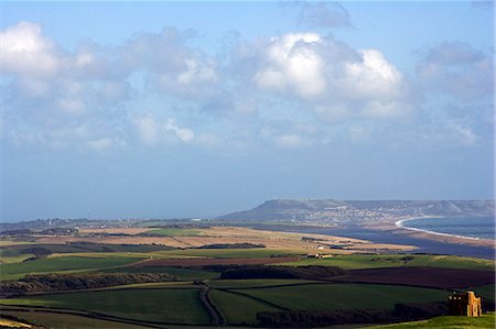 english countryside church - England,West Dorset,St Catherine's Chapel,Abbotsbury. Set high on a hilltop overlooking Abbotsbury Abbey,The Fleet and the UNESCO listed Jurassic Coastline,this sturdily buttressed and barrel-vaulted 14th-century chapel was built by the monks as a place of pilgrimage and retreat. Stock Photo - Rights-Managed, Code: 862-03353879