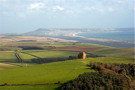 english countryside church - England,West Dorset,St Catherine's Chapel,Abbotsbury. Set high on a hilltop overlooking Abbotsbury Abbey,The Fleet and the UNESCO listed Jurassic Coastline,this sturdily buttressed and barrel-vaulted 14th-century chapel was built by the monks as a place of pilgrimage and retreat. Stock Photo - Rights-Managed, Code: 862-03353881