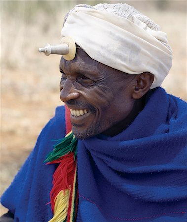 A Borana man at Mega in southern Ethiopia wears a phallic Kallaacha on his forehead. Made of cast aluminium and ivory or bone,the Kallaacha is worn during the tribe's initiation and gada age-grade ceremonies. The pastoral Borana live either side of the southern Ethiopian/northern Kenya border and form a large and important group of the Oromo-speaking cluster of tribes. Stock Photo - Rights-Managed, Code: 862-03353990