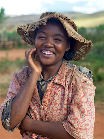 A happy Malagasy young woman despite her clothes which underscore her poverty. Stock Photo - Rights-Managed, Code: 862-03364015