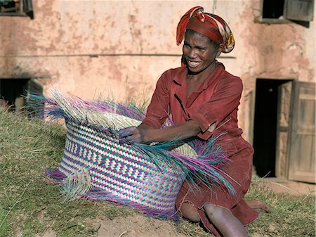 A Malagasy woman weaves a basket from raffia palm. Stock Photo - Rights-Managed, Code: 862-03364039