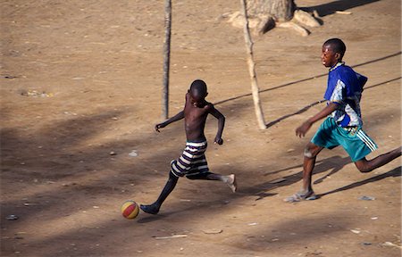 Boys playing football in the streets Stock Photo - Rights-Managed, Code: 862-03364092