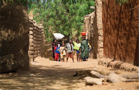 Crowd of colourful children in the backstreets of the village of Segoukoro on the banks of the River Niger Stock Photo - Rights-Managed, Code: 862-03364102