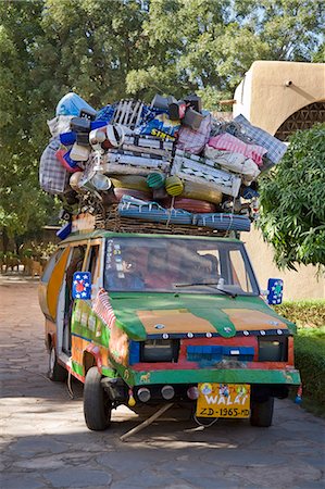 piled high - Mali,Bamako. An over-loaded small country bus on display at Musee National,Mali's National Museum,in Bamako. Stock Photo - Rights-Managed, Code: 862-03364117