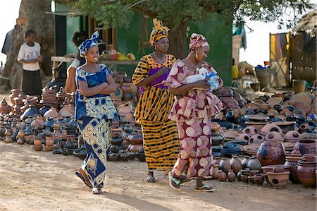 simsearch:862-03364149,k - Mali,Segou,Kalabougou. Women admire a large selection of clay pots and vessels at a stall in Segou. The female potters at the nearby village of Kalabougou are renowned for their fine pottery. Stock Photo - Rights-Managed, Code: 862-03364129