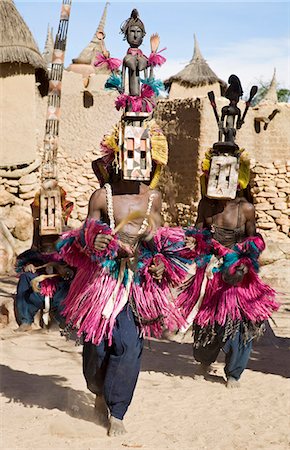 dogon mali - Mali,Dogon Country,Tereli. Masked dancers wearing the satimbe mask perform at the Dogon village of Tereli. This mask honours the primordial woman who is said to have discovered the original Dogon masks. The mask dance is staged at funeral ceremonies to appease the dead and speed them on their way to the ancestral world. Stock Photo - Rights-Managed, Code: 862-03364211