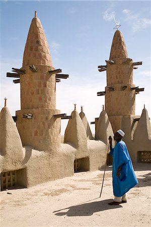 sudanese - Mali,Niger Inland Delta. Dwarfed by minarets,the imam of Kotaka Mosque calls the faithful to prayers from the roof of the mosque. Stock Photo - Rights-Managed, Code: 862-03364269