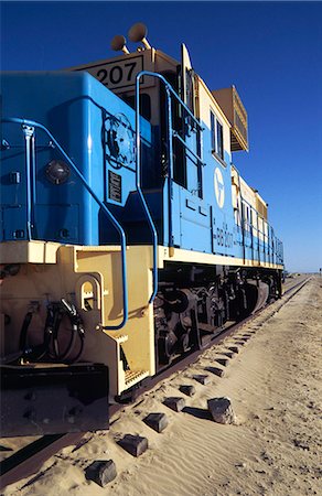 The locomotive for the worlds longest train sits at the station in Nouâdhibou. The full train is up to 2.5 kilometres long and trundles between Nouâdhibou and the iron mines of Zouérat in Mauritania. Stock Photo - Rights-Managed, Code: 862-03364319