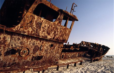 shipwreck - The rusting hulk of a freighter sits buried in the sands of the Plage des Pecheurs (Fishermens Beach) near Nouakchott in southern Mauritania Stock Photo - Rights-Managed, Code: 862-03364321