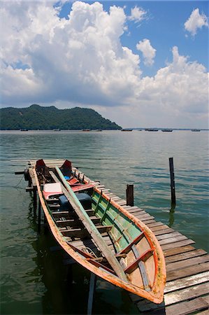 sandakan - Malaysia,Borneo,Sabah,Sandakan. Boat moored near the floating homes of Malays and Sea Gypsys who make thier living from the sea. Stock Photo - Rights-Managed, Code: 862-03364360