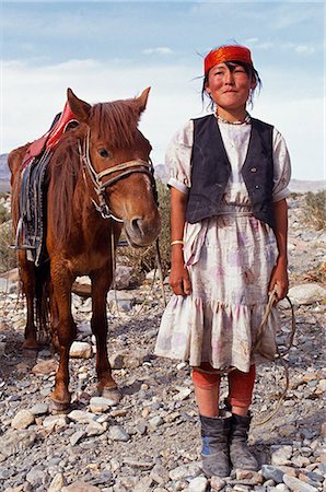 Mongolia,Khovd (also spelt Hovd) aimag (region),Kasakh girl with horse. Foto de stock - Con derechos protegidos, Código: 862-03364510