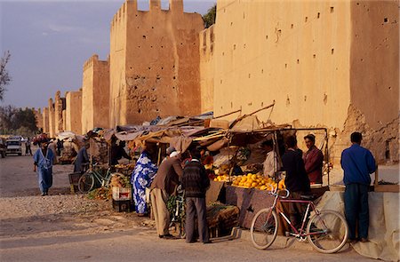 Fruit and vegetable sellers cluster by high,mud-brick walls that completely encircle the town of Taroudannt. Stock Photo - Rights-Managed, Code: 862-03364576