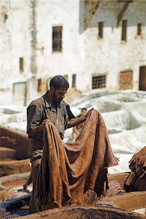 simsearch:700-03612982,k - A man working in the tanneries in Old Fez,Morocco. In the white pits,animal hides are soaked for a week in lime and bird droppings to bleach the skin and remove the hair. The skins are then moved to the brown pits where they are coloured using natural dyes. Stock Photo - Rights-Managed, Code: 862-03364624