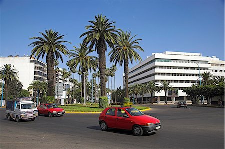 simsearch:862-03364662,k - A red Petit Taxi passes through the modern business district of Gauthier in Casablanca. Stock Photo - Rights-Managed, Code: 862-03364678