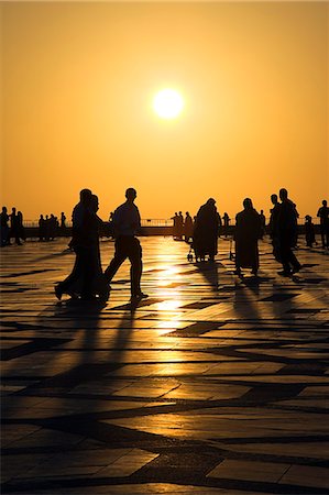 simsearch:862-03354589,k - Families and friends enjoy an evening stroll,or paseo,under the setting sun in the courtyard of the Hassan II Mosque in Cassablanca. Stock Photo - Rights-Managed, Code: 862-03364692