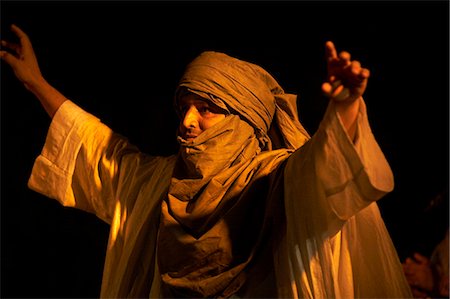 fez - Morocco,Fes. Wearing traditional robes,a Tuareg dances at a late evening concert during the Fes Festival of World Sacred Music. Foto de stock - Con derechos protegidos, Código: 862-03364817