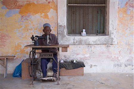 A man works his sewing machine on Ibo Island,part of the Quirimbas Archipelago,Mozambique Stock Photo - Rights-Managed, Code: 862-03364921