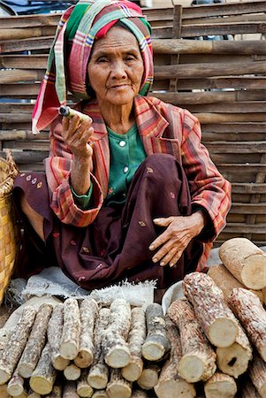 simsearch:862-03365100,k - Myanmar. Burma. Nyaung U. An old woman smokes a local cheroot as she sells thanahka - the bark of Lemonira acidissimo tree ground to a paste with water for use as sunscreen. Fotografie stock - Rights-Managed, Codice: 862-03365095