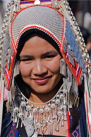 Myanmar,Burma,Kengtung. An Akha woman wearing traditional costume with a headdress of silver and glass beads. Stock Photo - Rights-Managed, Code: 862-03365223