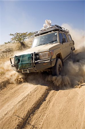 dirt roads in africa - Namibia,Damaraland. The desert environment and lack of paved roads in many the interior region means that the most travel is by four wheel drive vechicles. Stock Photo - Rights-Managed, Code: 862-03365377