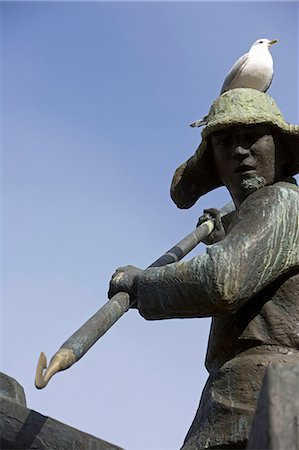 Tromso Troms, Norvège. Storgata, le centre des magasins du centre-ville et quartier commercial de Tromso, possède une statue célèbre Tromso baleinière du patrimoine qui forme un perchoir utile pour attentifs mouettes. Photographie de stock - Rights-Managed, Code: 862-03365566