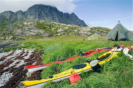 Norway,Nordland,Helgeland. A kayak expedition camps in the shadow of a coastal mountain Stock Photo - Rights-Managed, Code: 862-03365645