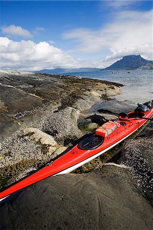 Norway,Nordland,Helgeland. A sea kayak is drawn up on the rocks after crossing a wide bay Stock Photo - Rights-Managed, Code: 862-03365653