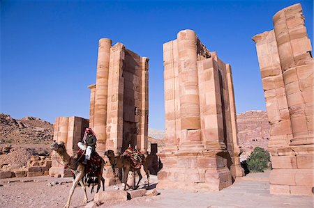 A camel passes through the Temenos Gateway on the Collonaded Street at Petra,Jordan Fotografie stock - Rights-Managed, Codice: 862-03365855