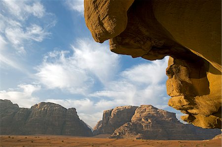 Jordan,Aqaba Region,Wadi Rum. One of the world's most spectacular desert landscapes,Wadi Rum has been a historical crossroads for Nabeatean traders heading from the Arabian Penisula,Lawrence of Arabia,and modern day adventure seekers. Stock Photo - Rights-Managed, Code: 862-03365934