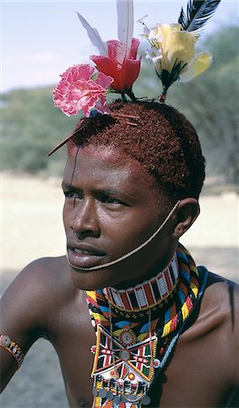 The adornments of Samburu warriors change from generation to generation. In the 1990's cheap plastic flowers from China became fashionable. Stock Photo - Rights-Managed, Code: 862-03366062