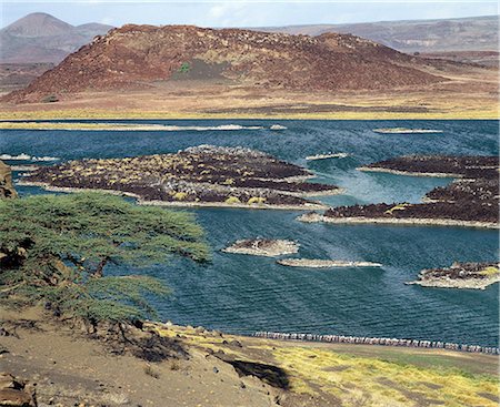 simsearch:862-03888751,k - At the southern end of Lake Turkana,just south of Von H_hnel Bay,lies a small,extremely alkaline lake which is fed from Lake Turkana underground. The colours of the water and the surrounding lava country can be vivid in certain light. Small flocks of lesser flamingos congregate here on rare occasions. Stock Photo - Rights-Managed, Code: 862-03366075