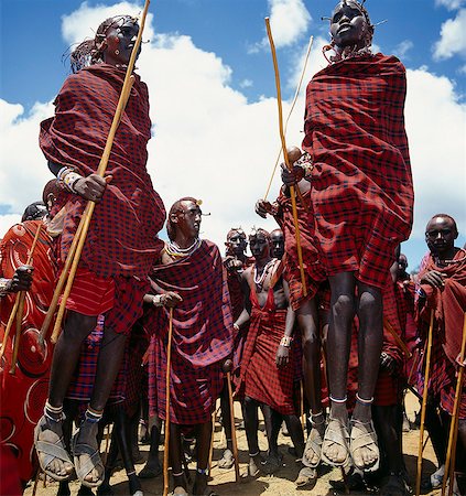 simsearch:862-03366431,k - During their dances,Maasai warriors take turns to leap high in the air from a standing position without bending their knees. They achieve this by flexing their ankles in a seemingly effortless way . Stock Photo - Rights-Managed, Code: 862-03366158