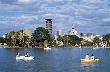 The Nairobi skyline from Uhuru Park where city residents enjoy rowing boats on a small artificial lake. The clock tower of Kenya's Parliament can be seen in the background. Stock Photo - Rights-Managed, Code: 862-03366211